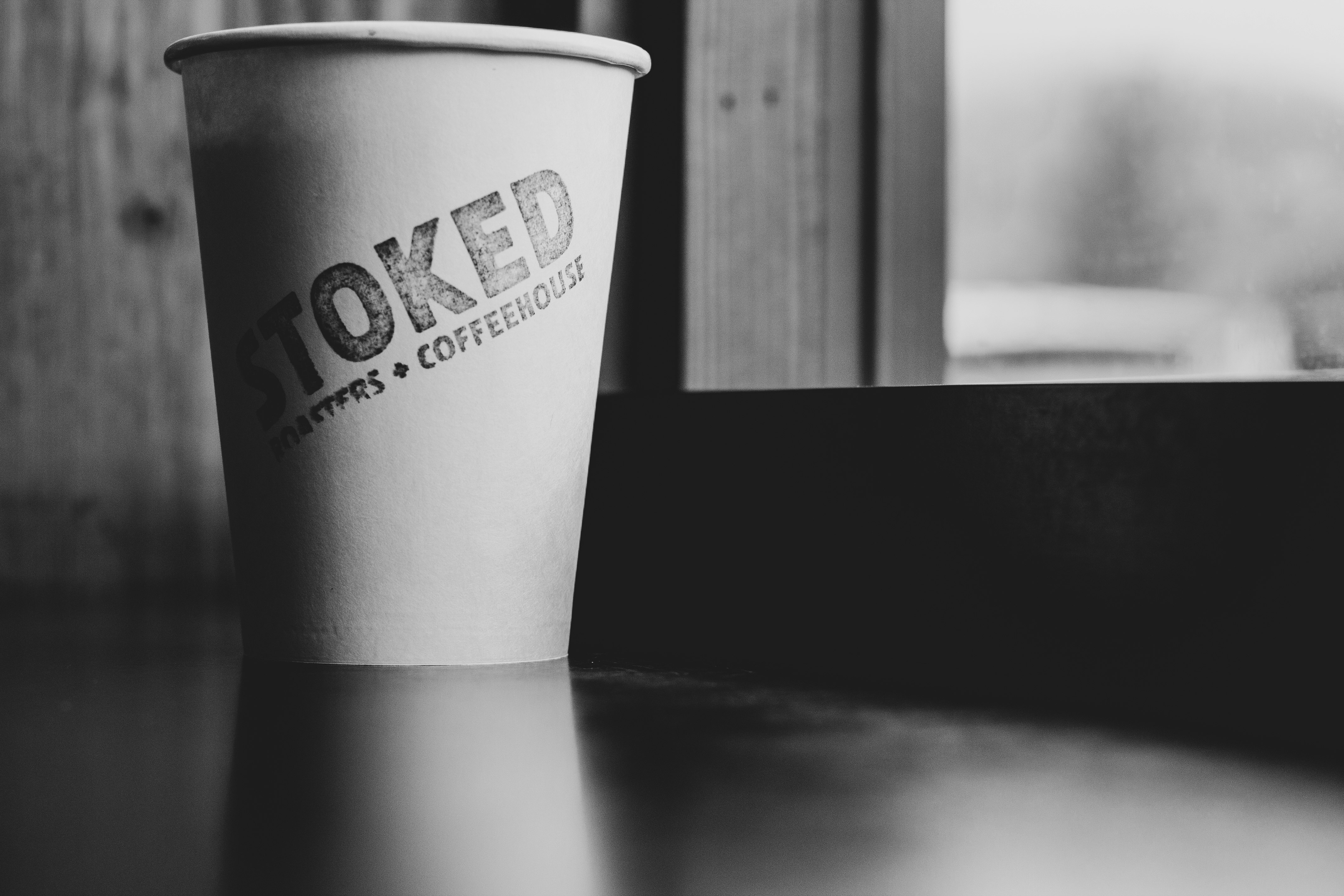 grayscale photo of stoked paper cup
